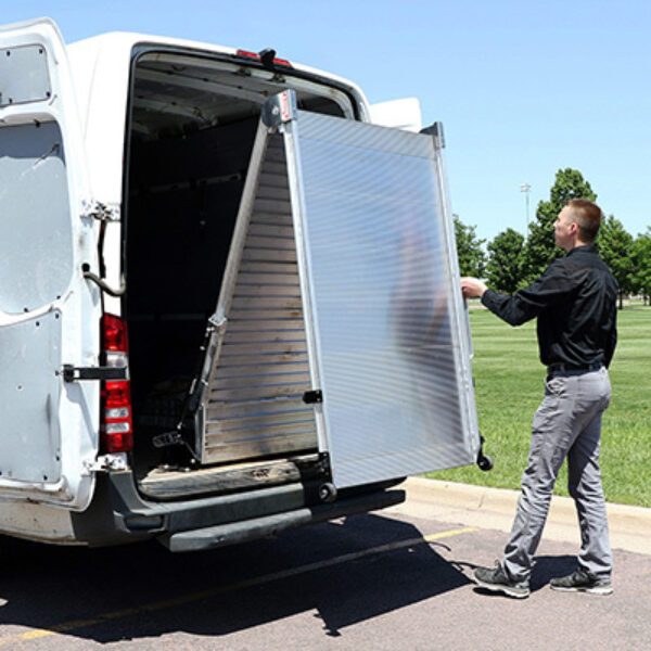 Man deploying LB20 ramp from rear of cargo van.