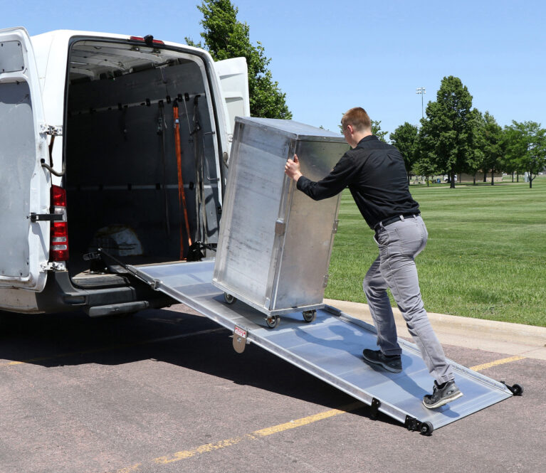 Man pushing a refrigerated unit up the LB20 ramp into a cargo van.
