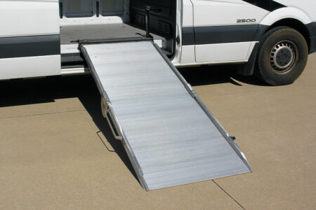 A mounted ramp extended and deployed out of the side of a cargo van