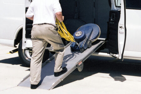 Man loading equipment using LB10 side door ramp