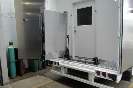 A Link swivel ramp folded outwards at 90 degrees on the back of a vehicle