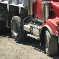 Tires on a dump truck, including a non-steerable lift axle
